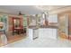 Open kitchen featuring white cabinetry, granite countertops, and a dining area at 230 Ridge Point Ct, Alpharetta, GA 30022