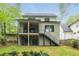 A beautiful two-story home with a spacious backyard and a two-level porch with stairs at 253 Rockyford Ne Rd, Atlanta, GA 30317