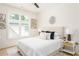 Comfortable bedroom with a queen bed, stylish decor, and large window allowing ample natural light at 253 Rockyford Ne Rd, Atlanta, GA 30317