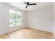 Bright bedroom with light hardwood floors and a large window offering a view of the home's exterior at 253 Rockyford Ne Rd, Atlanta, GA 30317