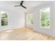 Bright, airy bedroom with light hardwood floors and large windows offering a view of surrounding greenery at 253 Rockyford Ne Rd, Atlanta, GA 30317