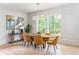 Elegant dining area with modern lighting and nature views from multiple windows at 253 Rockyford Ne Rd, Atlanta, GA 30317