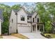 Charming two-story home with a two-car garage and inviting front porch surrounded by lush landscaping at 253 Rockyford Ne Rd, Atlanta, GA 30317