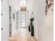 Elegant foyer featuring a hardwood floor, modern light fixture, decorative mirror, and a five-lite glass door at 253 Rockyford Ne Rd, Atlanta, GA 30317