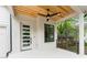 Inviting front porch features a ceiling fan and stylish white painted brick and door at 253 Rockyford Ne Rd, Atlanta, GA 30317