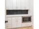 Neat kitchen area featuring custom white cabinets and drawers accented with sleek gold hardware at 253 Rockyford Ne Rd, Atlanta, GA 30317