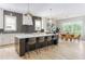 Well-lit kitchen flows into dining area, featuring island with barstool seating at 253 Rockyford Ne Rd, Atlanta, GA 30317