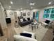 Open-concept living room boasts a stylish gray sofa, modern lighting, and a large window with natural light at 253 Rockyford Ne Rd, Atlanta, GA 30317