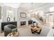 Bright living room with a fireplace, modern lighting, and a staircase at 253 Rockyford Ne Rd, Atlanta, GA 30317
