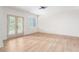 Bright living room with wood floors, a modern light fixture and access to the outdoors through glass doors at 253 Rockyford Ne Rd, Atlanta, GA 30317