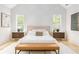 Bright primary bedroom with vaulted ceiling, geometric accent wall, and large windows offering serene views at 253 Rockyford Ne Rd, Atlanta, GA 30317