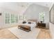 Spacious and bright main bedroom featuring vaulted ceilings, decorative wall panels, and abundant natural light at 253 Rockyford Ne Rd, Atlanta, GA 30317