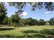 A public park with a playground surrounded by a large grassy field and mature trees at 253 Rockyford Ne Rd, Atlanta, GA 30317