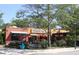 Exterior shot of Universal Joint restaurant showcasing outdoor patio seating and lush landscaping at 253 Rockyford Ne Rd, Atlanta, GA 30317