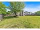 Expansive backyard with lush green grass, mature trees, and a private fence at 3477 Seneca Farm Dr, Buford, GA 30519