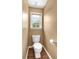 Powder bathroom features wood flooring and a window with a view of outdoors at 3477 Seneca Farm Dr, Buford, GA 30519