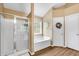 Bathroom featuring a glass-enclosed shower, separate tub, and updated fixtures for a modern feel at 3477 Seneca Farm Dr, Buford, GA 30519