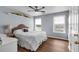 Cozy bedroom with hardwood floors, natural light and large windows. Decorated with light grey tones at 3477 Seneca Farm Dr, Buford, GA 30519