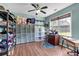 Craft room with ceiling fan, hardwood flooring and a large window allowing lots of natural light at 3477 Seneca Farm Dr, Buford, GA 30519