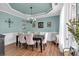 Formal dining room with a chandelier, wainscoting, and seating for six around a dark wood table at 3477 Seneca Farm Dr, Buford, GA 30519