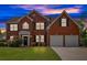 Charming two-story red brick home with a well-manicured lawn and attached two car garage at 3477 Seneca Farm Dr, Buford, GA 30519