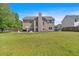 Large backyard featuring a well-maintained lawn and outdoor seating area at 3477 Seneca Farm Dr, Buford, GA 30519