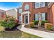 Charming exterior view of a brick home with black shutters, a manicured lawn and flower beds at 3477 Seneca Farm Dr, Buford, GA 30519