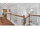 Bright foyer with hardwood floors, a staircase with white spindles, and a view into the living spaces at 3477 Seneca Farm Dr, Buford, GA 30519