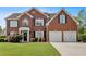 Charming two-story brick home featuring a manicured front lawn and a two-car garage at 3477 Seneca Farm Dr, Buford, GA 30519