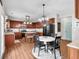 Eat-in kitchen featuring dark wood cabinets, stainless steel appliances, and a center island at 3477 Seneca Farm Dr, Buford, GA 30519