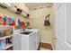 Well-organized laundry room with shelving, front-load machines, and ample storage for cleaning supplies at 3477 Seneca Farm Dr, Buford, GA 30519