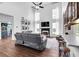 Open-concept living room with high ceilings, fireplace, and adjacent breakfast bar at 3477 Seneca Farm Dr, Buford, GA 30519