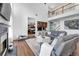 Comfortable living room features hardwood floors and plush seating with fireplace and view of upper level at 3477 Seneca Farm Dr, Buford, GA 30519