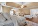 Comfortable bedroom with a plush bed, tray ceiling, and open access to other parts of the home at 3477 Seneca Farm Dr, Buford, GA 30519