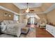 Large primary bedroom featuring vaulted ceilings and a seating area with comfortable chairs at 3477 Seneca Farm Dr, Buford, GA 30519