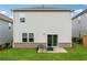 Home exterior featuring patio with fire pit, and view of the grassy back yard at 4777 Waxwing St, Hoschton, GA 30548