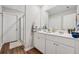 Clean bathroom with a double sink vanity, white cabinets, and a glass-enclosed shower at 4777 Waxwing St, Hoschton, GA 30548