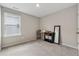 Minimalist bedroom featuring carpet floors, neutral walls, and a large window at 4777 Waxwing St, Hoschton, GA 30548