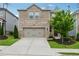 Charming two-story brick home with a well-manicured front yard and an attached two-car garage at 4777 Waxwing St, Hoschton, GA 30548