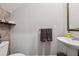 Stylish half-bathroom featuring modern sink, decorative wall texture and shelf decor at 4777 Waxwing St, Hoschton, GA 30548