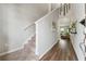 Inviting hallway with hardwood floors, a staircase, and neutral-toned walls, leading to the living area at 4777 Waxwing St, Hoschton, GA 30548