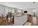 Kitchen island with granite countertops, stainless steel appliances, and an open view to the living area at 4777 Waxwing St, Hoschton, GA 30548