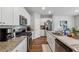 Well-equipped kitchen with stainless steel appliances, granite countertops, and white cabinets at 4777 Waxwing St, Hoschton, GA 30548