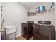 Functional laundry room with updated washer and dryer, and plenty of storage at 4777 Waxwing St, Hoschton, GA 30548