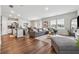 Open concept living room featuring hardwood floors, natural light, and modern furnishings at 4777 Waxwing St, Hoschton, GA 30548