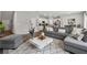 Bright, open-concept living room with hardwood floors, neutral décor, and a comfortable gray sectional at 4777 Waxwing St, Hoschton, GA 30548