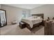 Comfortable bedroom with carpet, a large bed, and ample natural light through the window at 4777 Waxwing St, Hoschton, GA 30548