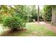Large, serene backyard featuring mature trees and a storage shed, creating a peaceful outdoor oasis at 2227 Leafmore Drive, Decatur, GA 30033