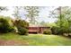 A lovely deck looks out over the spacious green lawn and well-maintained landscaping at 2227 Leafmore Drive, Decatur, GA 30033