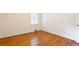A cozy bedroom featuring beautiful hardwood floors and a bright window with white shutters at 2227 Leafmore Drive, Decatur, GA 30033